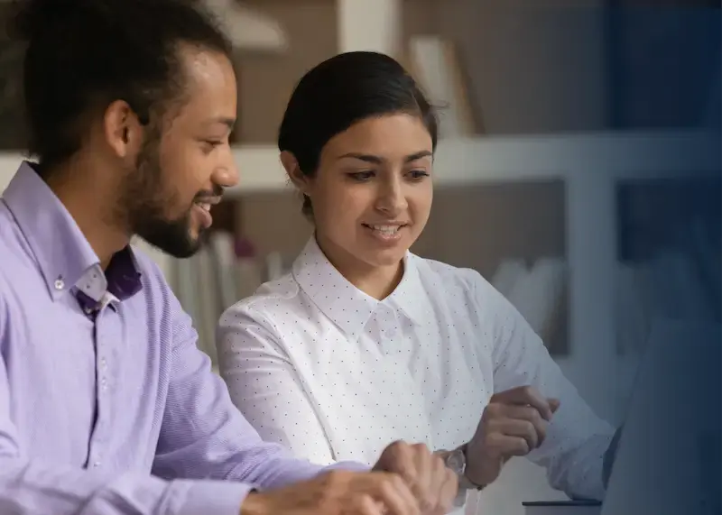 two students sharing a laptop.