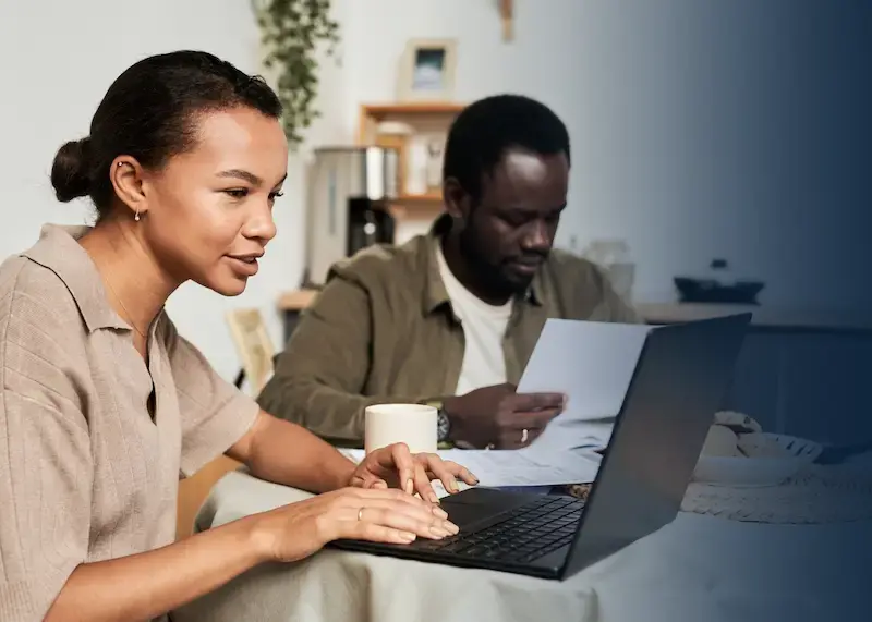 two research students working at a desk.