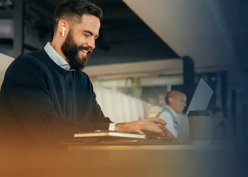 young business man receiving an employee reward on his laptop while working in a cafe.