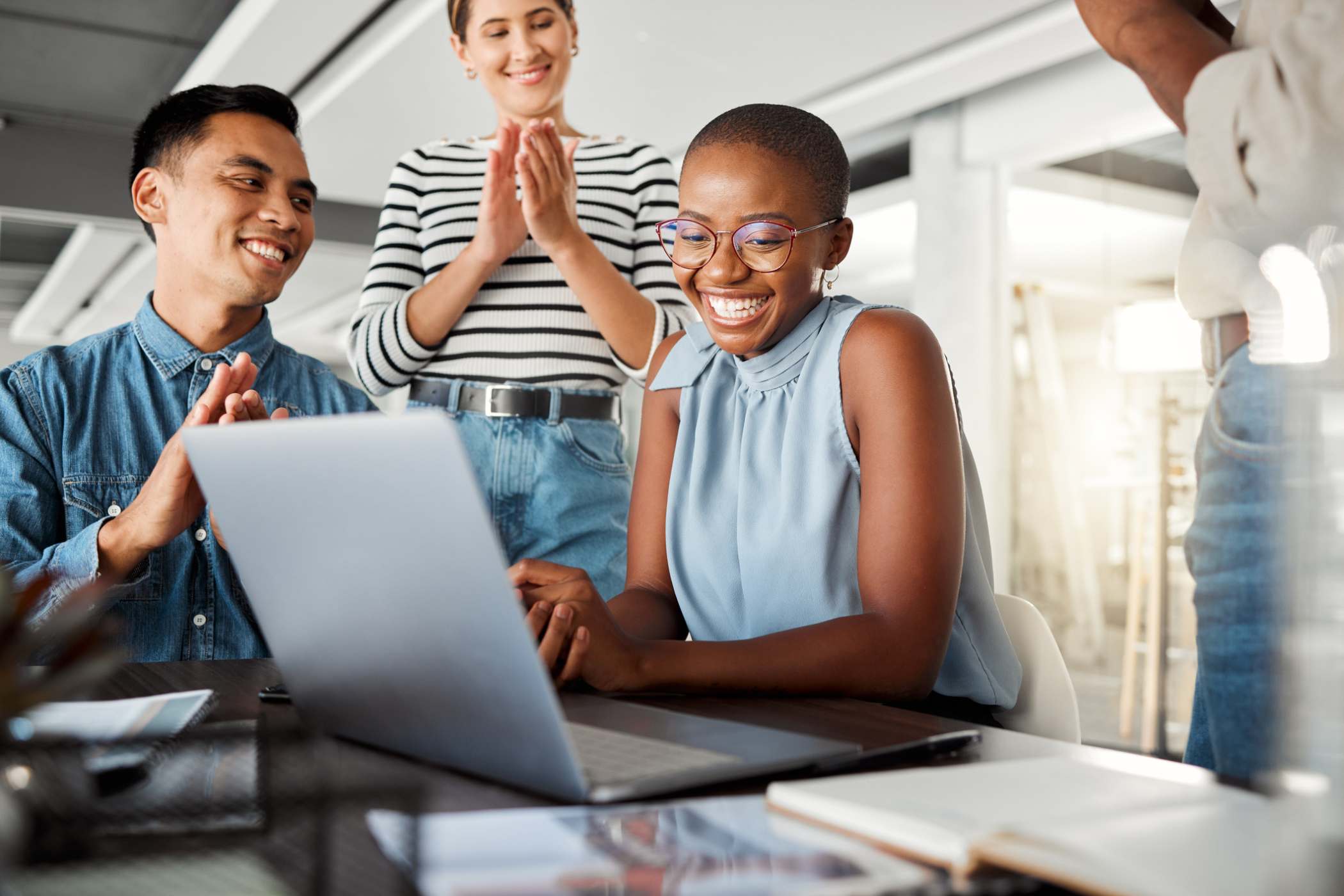 employees clapping for and recognizing a colleague