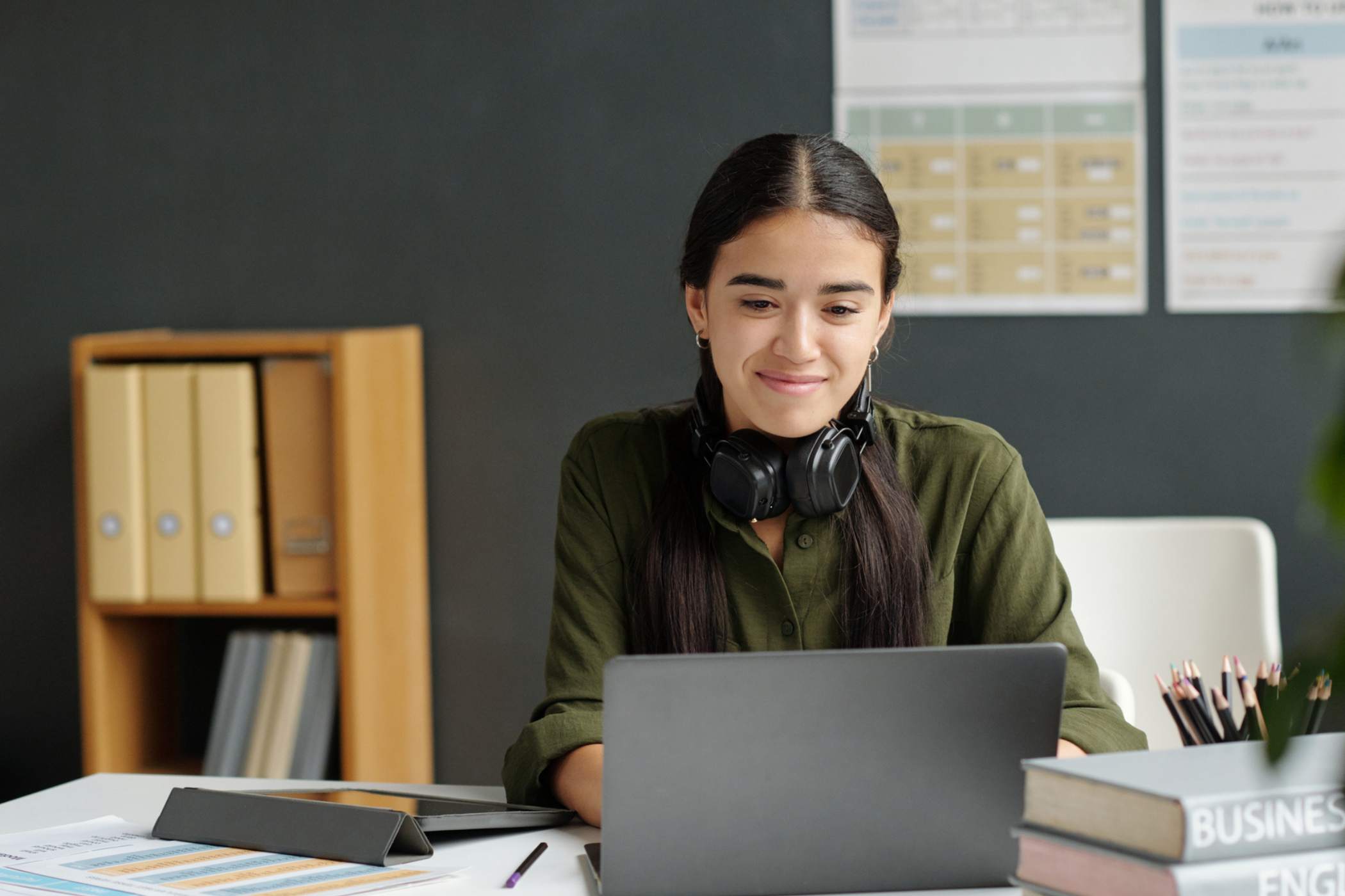 engaged edtech student sitting at desk with laptop