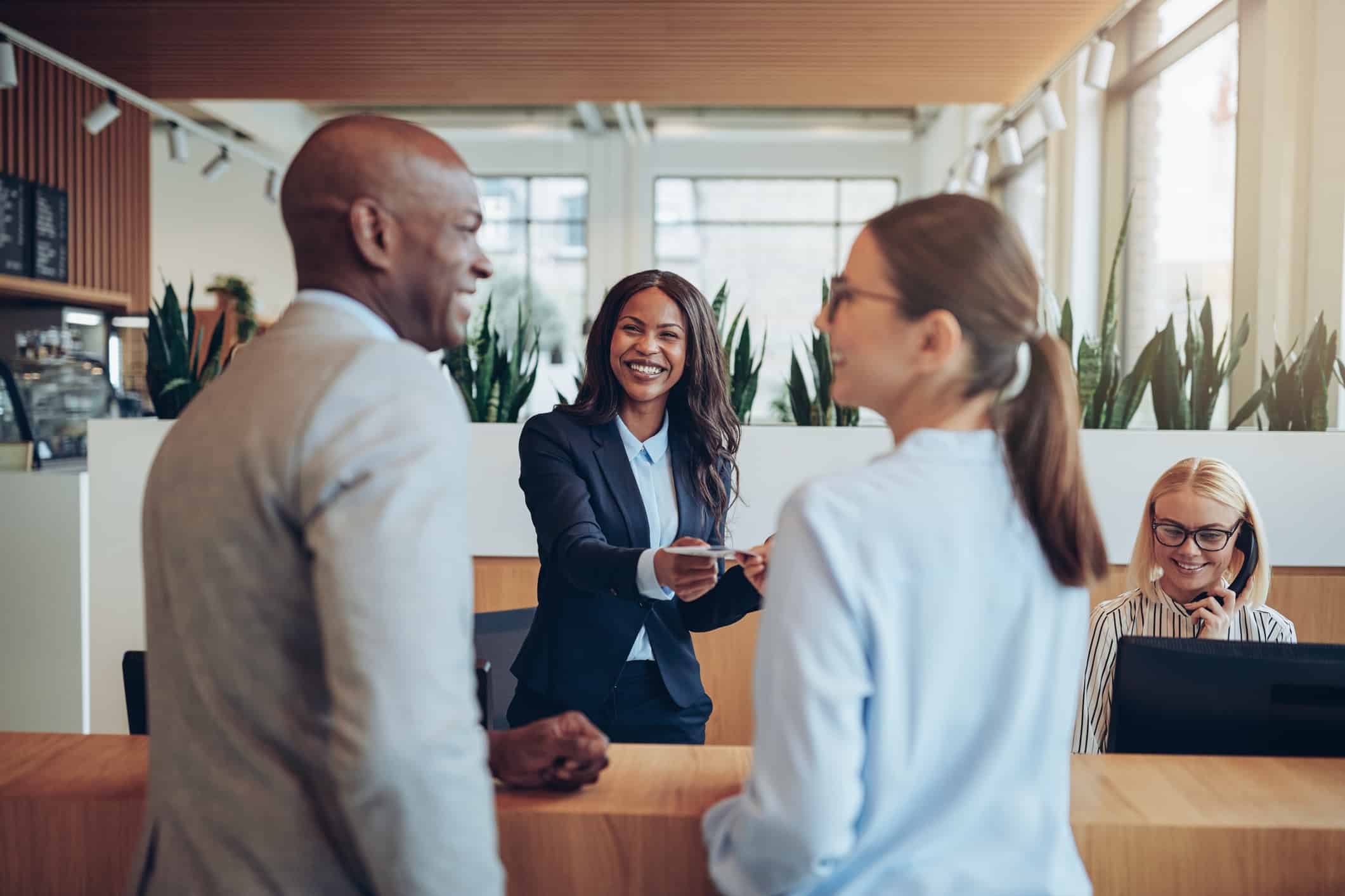 Hotel Employee welcoming couple to the hotel during the busy hospitality season