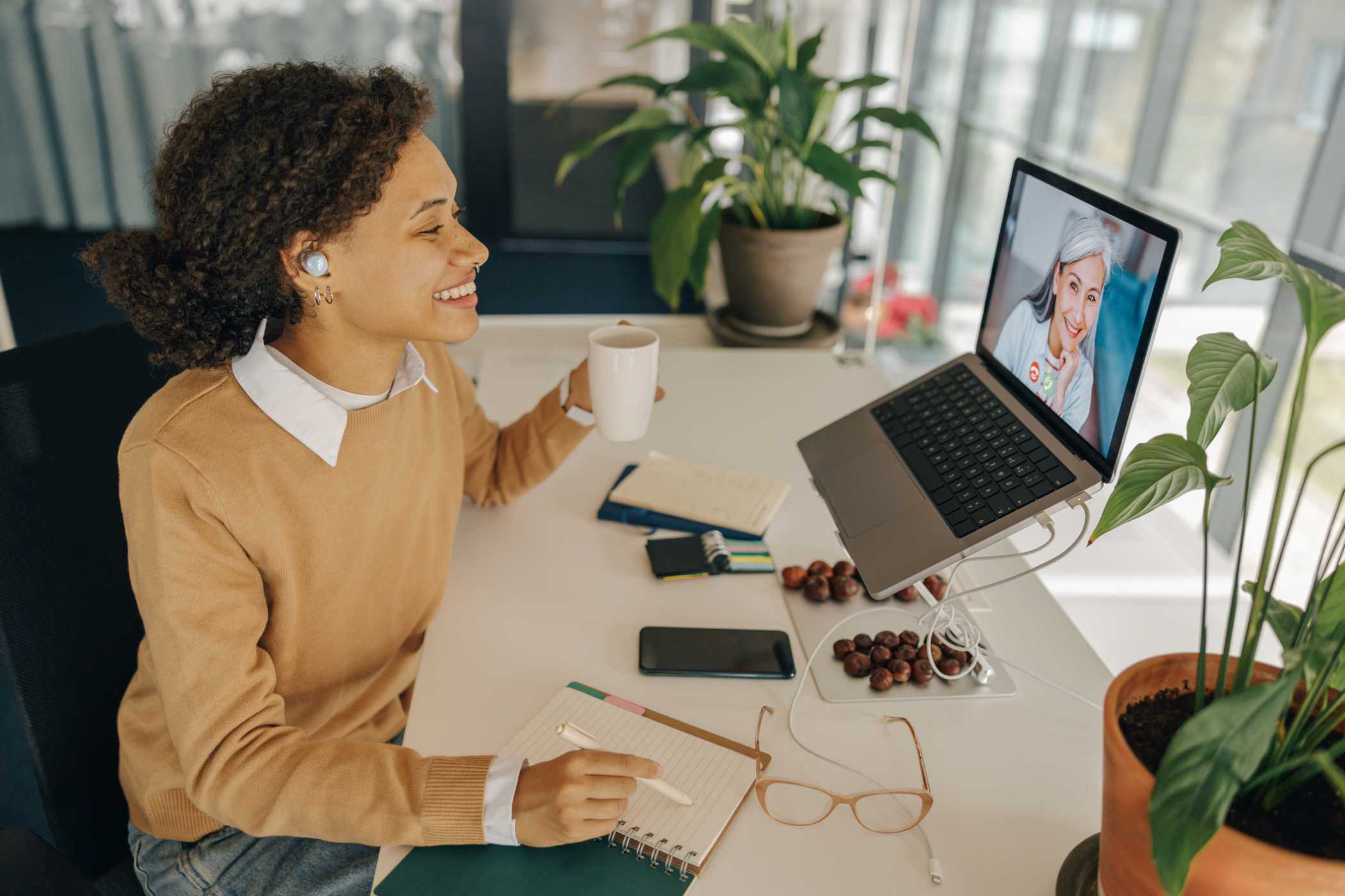 saleswoman taking notes on a video sales call