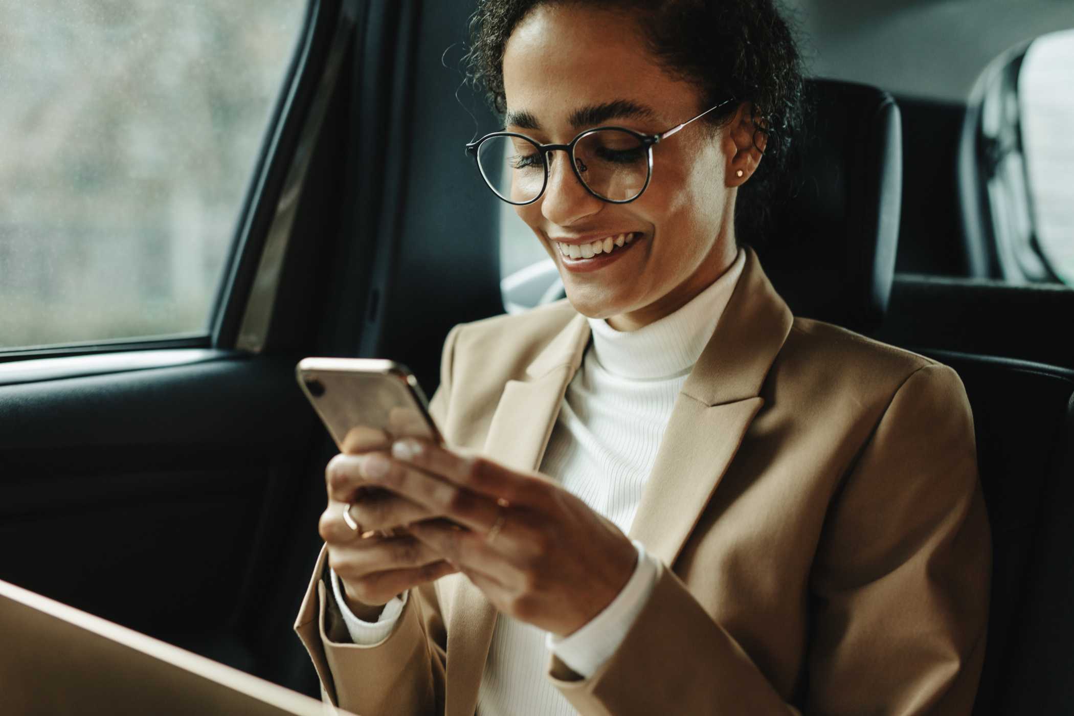 smiling woman using phone to access digital gift card.jpg