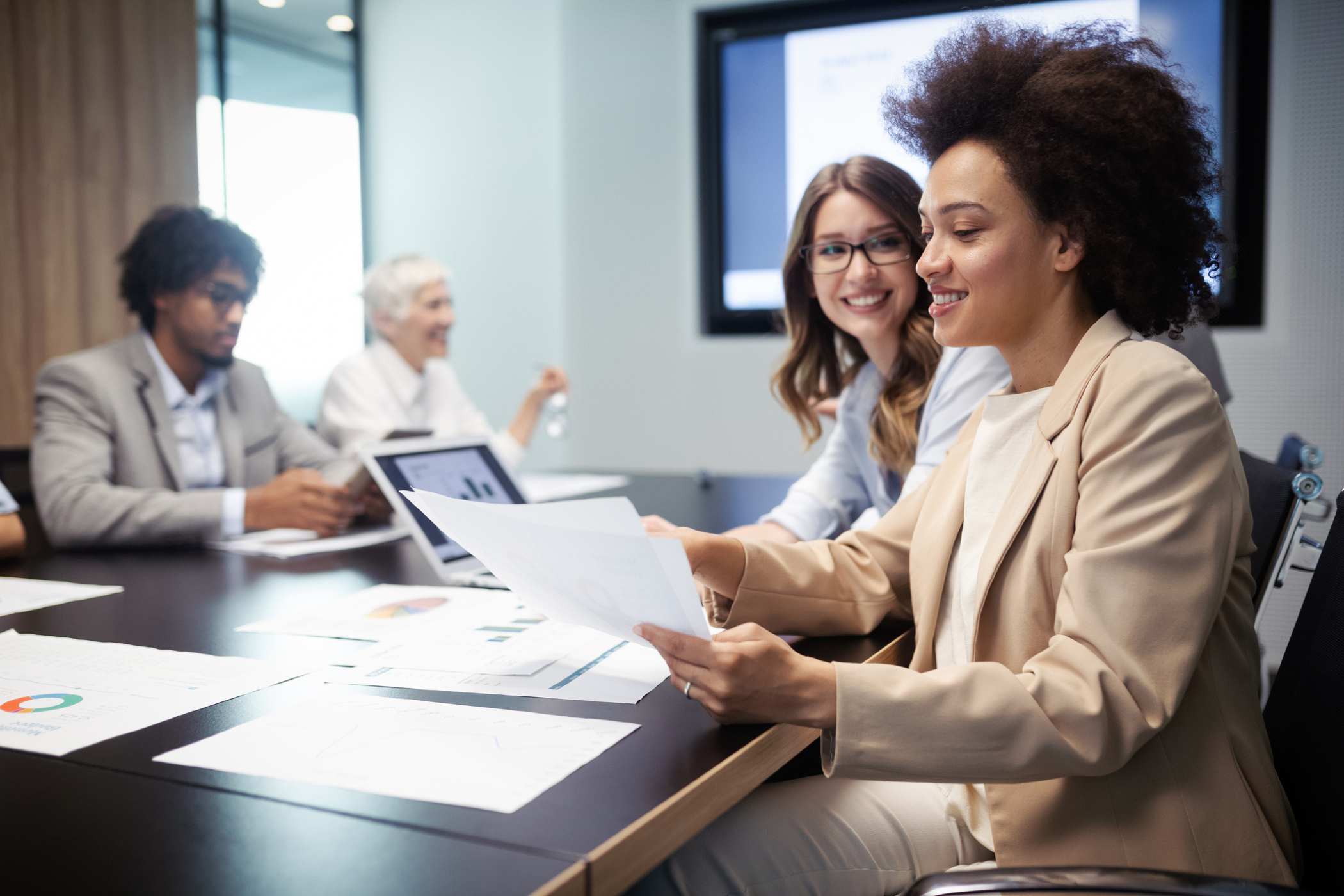 two employees presenting at a business meeting