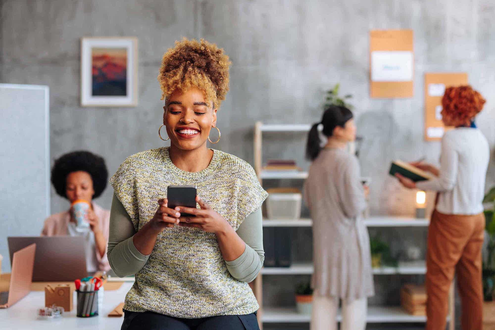 woman using a cell phone to receive a virtual prepaid Mastercard