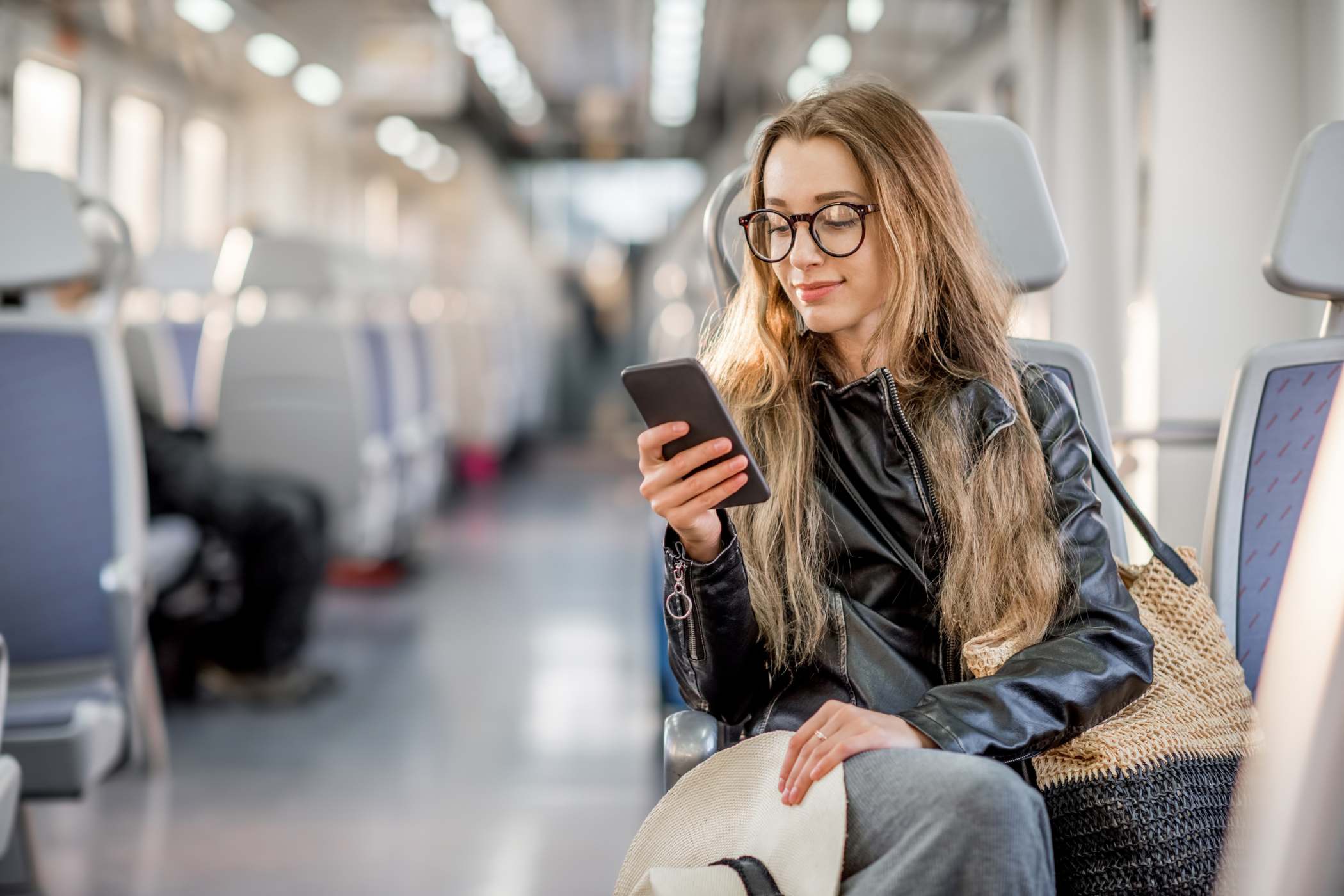 woman looking at her phone on a modern European train